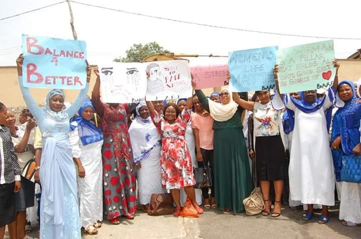 Women advocacy group holding Balance for Better signs